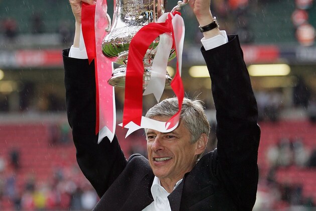 CARDIFF, UNITED KINGDOM - MAY 21:  Arsenal Manager, Arsene Wenger holds aloft the trophy after winning the FA Cup Final between Arsenal and Manchester United 5-4 on penalty's at The Millennium Stadium on May 21, 2005 in Cardiff, Wales.  (Photo by Ross Kinnaird/Getty Images)