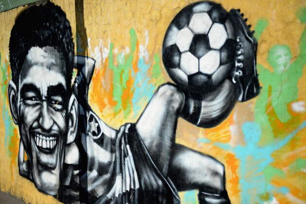 RIO DE JANEIRO, BRAZIL - JUNE 12:  Graffiti Art showing former Brazilian World Cup winner Garrincha on June 12, 2013 in Rio de Janeiro, Brazil.  (Photo by Laurence Griffiths/Getty Images)
