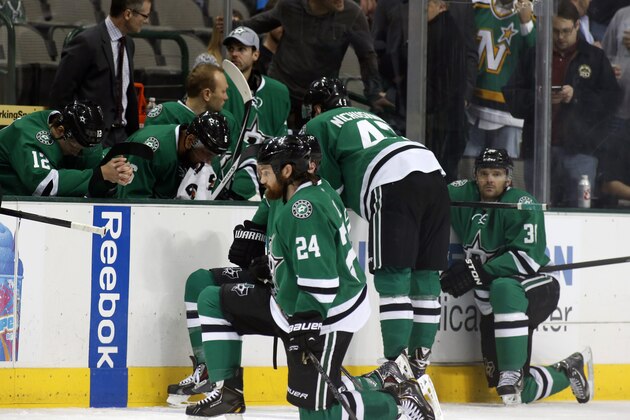 Dallas Stars right wing Alex Chiasson (12) bows his head on the bench as defenseman Jordie Benn (24) takes a knee on the ice after play was stopped in the first period of an NHL Hockey game against the Columbus Blue Jackets, Monday, March 10, 2014, in Dallas. Stars center Rich Peverly was taken to a hospital after a medical emergency. (AP Photo/Sharon Ellman)
