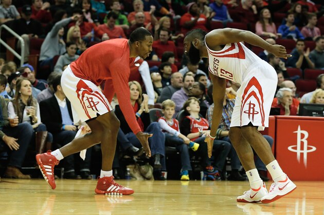 HOUSTON, TX - DECEMBER 08:   Dwight Howard #12 and James Harden #13 of the Houston Rockets greet each other during a timeout during the game against the Orlando Magic at Toyota Center on December 8, 2013 in Houston, Texas. NOTE TO USER: User expressly acknowledges and agrees that, by downloading and or using this photograph, User is consenting to the terms and conditions of the Getty Images License Agreement. (Photo by Scott Halleran/Getty Images)