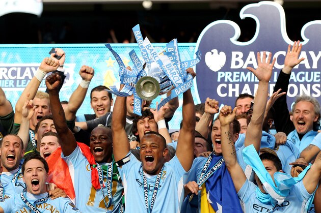 MANCHESTER, ENGLAND - MAY 13:  Vincent Kompany the captain of Manchester City lifts the trophy following the Barclays Premier League match between Manchester City and Queens Park Rangers at the Etihad Stadium on May 13, 2012 in Manchester, England.  (Photo by Alex Livesey/Getty Images)