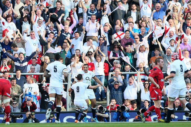 England's Luther Burrell, center, celebrates with his teammates after scoring a try against Wales during the Six Nations Rugby Union match between England and Wales at Twickenham stadium in London Sunday, March, 9, 2014. (AP Photo/Alastair Grant)