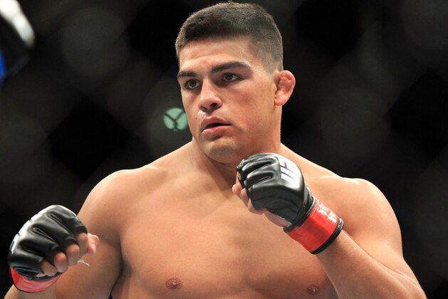 Aug 28, 2013; Indianapolis, IN, USA; Kelvin Gastelum (red gloves) fights Brian Melancon during UFC Fight Night 27 at Bankers Life Fieldhouse. Mandatory Credit: Pat Lovell-USA TODAY Sports