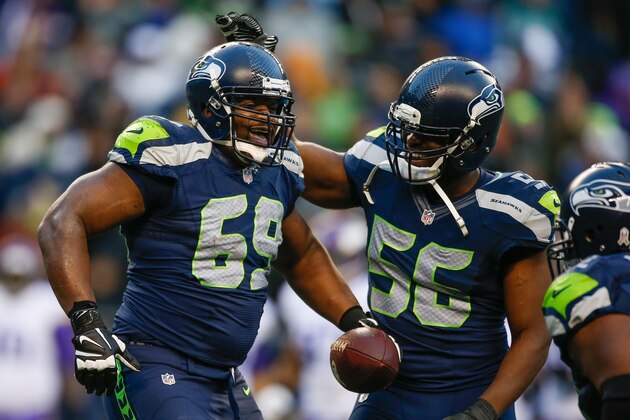 SEATTLE, WA - NOVEMBER 17:  Defensive tackle Clinton McDonald #69 (L) of the Seattle Seahawks is congratulated by defensive end Cliff Avril #56 after making an interception against the Minnesota Vikings at CenturyLink Field on November 17, 2013 in Seattle, Washington. The Seahawks defeated the Vikings 41-20.  (Photo by Otto Greule Jr/Getty Images)