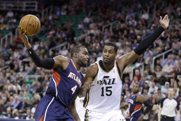 Atlanta Hawks' Paul Millsap (4) drives to the basket as Utah Jazz's Derrick Favors (15) defends in the second quarter during an NBA basketball game Monday, March 10, 2014, in Salt Lake City. (AP Photo/Rick Bowmer)