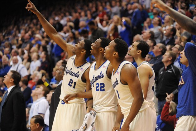 Feb 22, 2014; Lawrence, KS, USA; Kansas Jayhawks center Joel Embiid (21), guard Andrew Wiggins (22), forward Perry Ellis (34) and guard Wayne Selden, Jr. (1) react to a dunk in the second half against the Texas Longhorns at Allen Fieldhouse. Kansas won 85-54. Mandatory Credit: Denny Medley-USA TODAY Sports