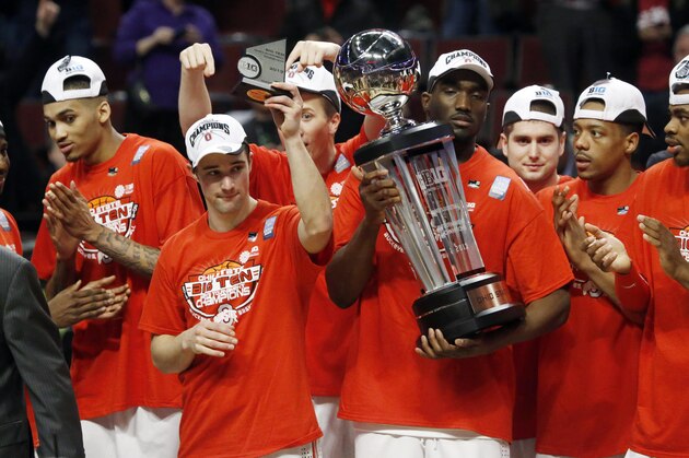 Ohio State guard Aaron Craft holds up his MVP trophy as he celebrates with forward Evan Ravenel holding up the Big Ten Championship trophy after an NCAA college basketball game against Wisconsin in the championship of the Big Ten tournament Sunday, March 17, 2013, in Chicago. Ohio State won 50-43. (AP Photo/Charles Rex Arbogast)