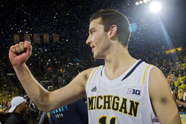 Michigan guard Nik Stauskas (11) cheers after an NCAA college basketball game against Indiana in Ann Arbor, Mich., Saturday, March 8, 2014. Michigan won 84-80. (AP Photo/Tony Ding)