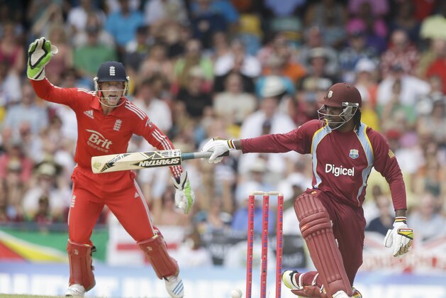 West Indies' Chris Gayle kneels down as he watches his shot as England's wicket keeper Jos Buttler screams during their first T20 International cricket match at the Kensington Oval in Bridgetown, Barbados, Sunday, March 9, 2014. (AP Photo/Ricardo Mazalan) West Indies' Chris Gayle kneels down as he watches his shot as England's wicket keeper Jos Buttler screams during their first T20 International cricket match at the Kensington Oval in Bridgetown, Barbados, Sunday, March 9, 2014. (AP Photo/Ricardo Mazalan)