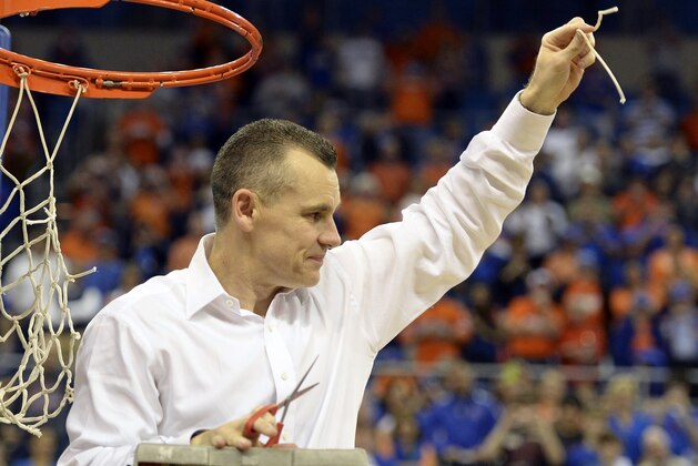 Florida coach Billy Donovan holds up a piece of the net after the Gators became the first team in Southeastern Conference history to go 18-0 in league pla, Saturday, March 8, 2014 in Gainesville, Fla. Florida defeated Kentucky 84-65 Saturday in an NCAA college basketball game. (AP Photo/Phil Sandlin)