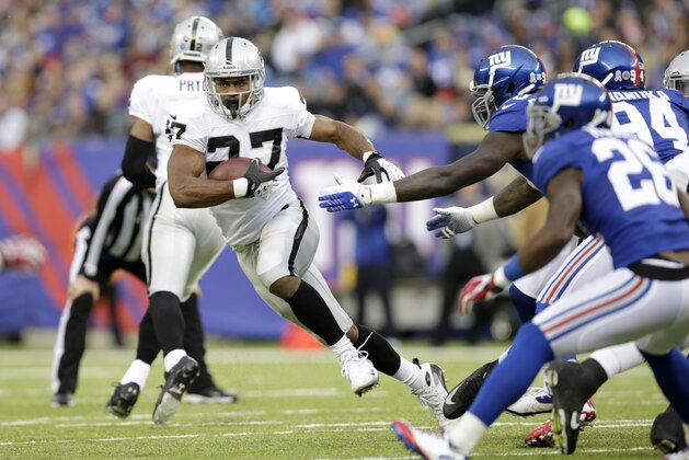 Oakland Raiders running back Rashad Jennings (27) runs with the ball against the New York Giants during the first half of an NFL football game, Sunday, Nov. 10, 2013, in East Rutherford, N.J. (AP Photo/Kathy Willens)