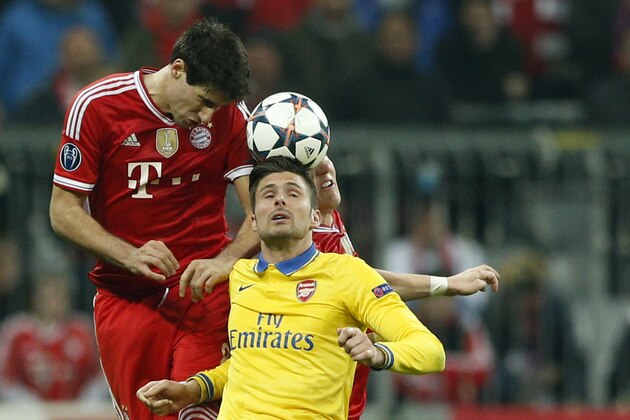 Arsenal's Oliver Giroud, front, and Bayern's Javier Martinez, left, and Bastian Schweinsteiger go for a header during the Champions League round of 16 second leg soccer match between FC Bayern Munich and FC Arsenal in Munich, Germany, Wednesday, March 12, 2014. (AP Photo/Matthias Schrader)