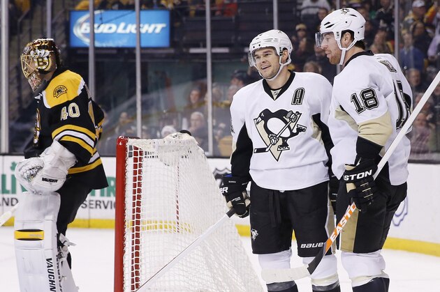 Pittsburgh Penguins' Chris Kunitz, center, celebrates his goal with teammate James Neal (18) as Boston Bruins' Tuukka Rask (40) stands in the net in the first period of an NHL hockey game in Boston, Saturday, Dec. 7, 2013. (AP Photo/Michael Dwyer)