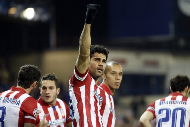 Atletico's Diego Costa celebrates scoring the opening goal during a Champions League, round of 16, second leg, soccer match between Atletico Madrid and AC Milan at the Vicente Calderon stadium in Madrid, Tuesday March 11, 2014. (AP Photo/Paul White)