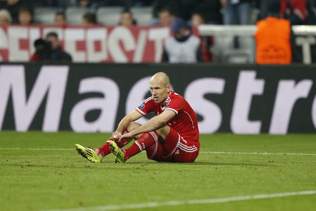 Bayern's Arjen Robben sits on the pitch during the Champions League round of 16 second leg soccer match between FC Bayern Munich and FC Arsenal in Munich, Germany, Wednesday, March 12, 2014. (AP Photo/Matthias Schrader)
