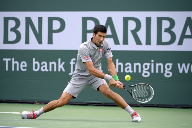 Novak Djokovic, of Serbia, volleys with Alejandro Gonzalez, of Colombia, in a third round match at the BNP Paribas Open tennis tournament, Tuesday, March 11, 2014, in Indian Wells, Calif. (AP Photo/Mark J. Terrill)