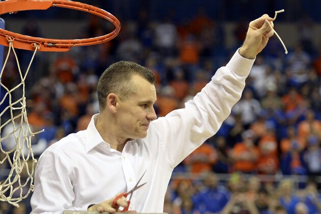 Florida coach Billy Donovan holds up a piece of the net after the Gators became the first team in Southeastern Conference history to go 18-0 in league pla, Saturday, March 8, 2014 in Gainesville, Fla. Florida defeated Kentucky 84-65 Saturday in an NCAA college basketball game. (AP Photo/Phil Sandlin)
