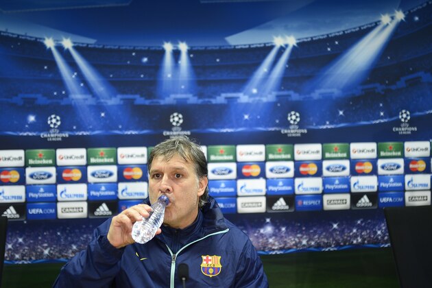 FC Barcelona's coach Gerardo Tata Martino, from Argentina, attends a news conference at the Sports Center FC Barcelona Joan Gamper in San Joan Despi, Spain, Tuesday, March 11, 2014. . FC Barcelona will play against Manchester City in a last sixteen Champions League soccer match on Wednesday March 12. (AP Photo/Manu Fernandez)