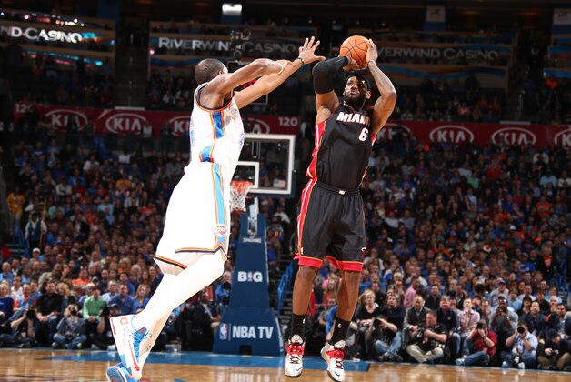 OKLAHOMA CITY, OK - FEBRUARY 20: LeBron James #6 of the Miami Heat shoots against Kevin Durant #35 of the Oklahoma City Thunder during a game at Chesapeake Energy Arena on February 20, 2014 in Oklahoma City, Oklahoma. NOTE TO USER: User expressly acknowledges and agrees that, by downloading and/or using this photograph, user is consenting to the terms and conditions of the Getty Images License Agreement.  Mandatory Copyright Notice: Copyright 2014 NBAE (Photo by Nathaniel S. Butler/NBAE via Getty Images)