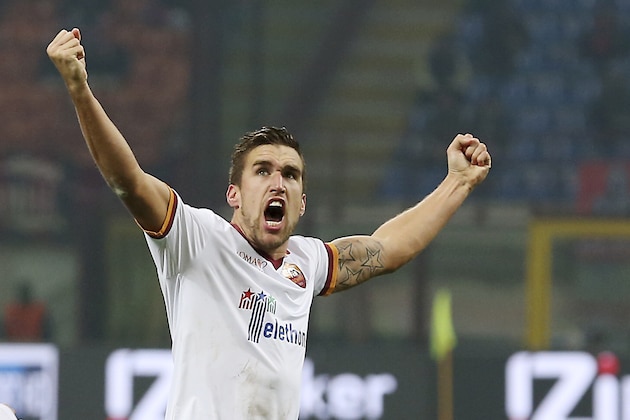 AS Roma midfielder Kevin Strootman, of the Netherlands, celebrates after scoring during the Serie A soccer match between AC Milan and Roma at the San Siro stadium in Milan, Italy, Monday, Dec. 16, 2013. (AP Photo/Antonio Calanni)