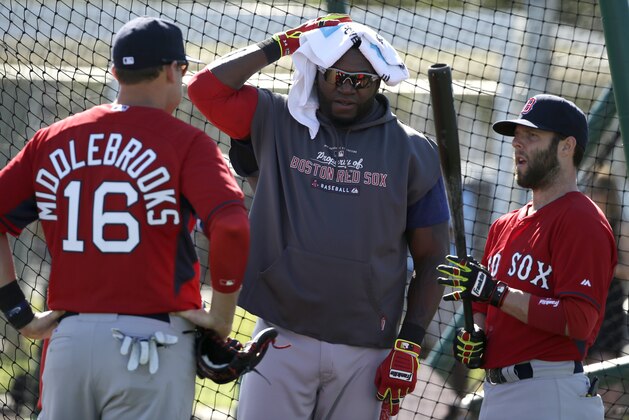 Boston Red Sox designated hitter David Ortiz, center, adjusts a towel on his head while talking with third baseman Will Middlebrooks, left, and second baseman Dustin Pedroia, right, during spring training baseball practice Tuesday, Feb. 18, 2014, in Fort Myers, Fla. (AP Photo/Steven Senne)