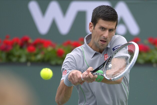 Novak Djokovic, of Serbia, returns a shot to Alejandro Gonzalez, of Colombia, in a third round match at the BNP Paribas Open tennis tournament, Tuesday, March 11, 2014, in Indian Wells, Calif. (AP Photo/Mark J. Terrill)