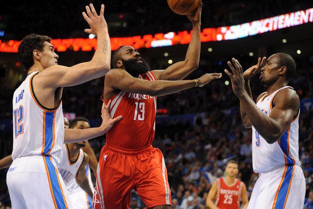 Mar 11, 2014; Oklahoma City, OK, USA;  Houston Rockets shooting guard James Harden (13) attempts a shot against Oklahoma City Thunder small forward Kevin Durant (35) and Oklahoma City Thunder center Steven Adams (12) during the first quarter at Chesapeake Energy Arena. Mandatory Credit: Mark D. Smith-USA TODAY Sports