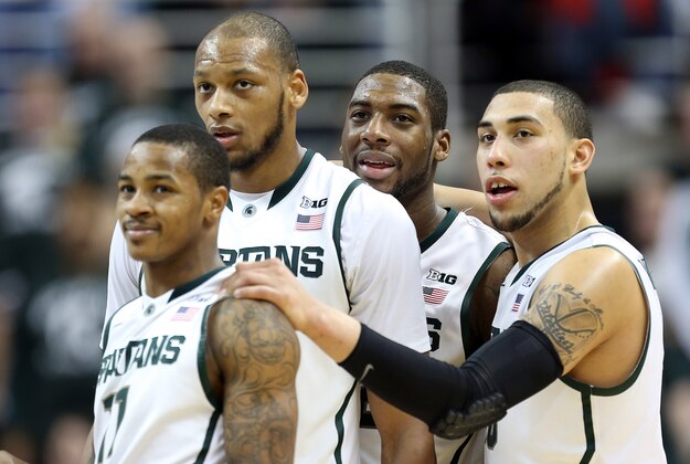 Mar 6, 2014; East Lansing, MI, USA; Michigan State Spartans guard Keith Appling (11) and forward Adreian Payne (5) and guard/forward Branden Dawson (22) and guard Denzel Valentine (45) stand on the court during the 2nd half of a game at Jack Breslin Student Events Center. MSU won 86-76. Mandatory Credit: Mike Carter-USA TODAY Sports