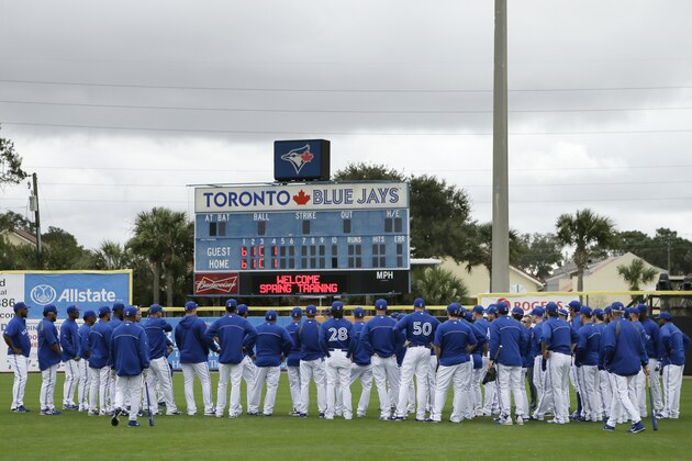 Toronto Blue Jays players gather in the outfield before an exhibition baseball game against the Tampa Bay Rays Friday, March 7, 2014, in Dunedin, Fla. (AP Photo/Charlie Neibergall)