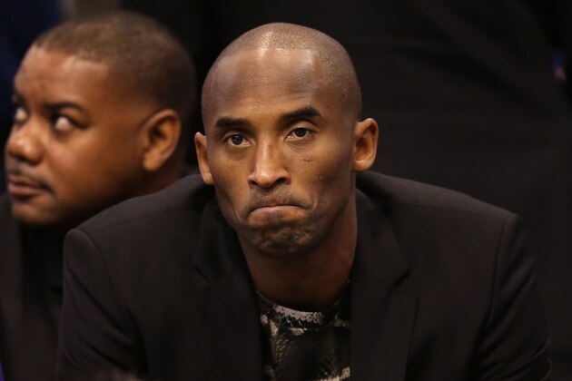 PHOENIX, AZ - JANUARY 15:  Kobe Bryant #24 of the Los Angeles Lakers watches from the bench during the NBA game against the Phoenix Suns at US Airways Center on January 15, 2014 in Phoenix, Arizona.  NOTE TO USER: User expressly acknowledges and agrees that, by downloading and or using this photograph, User is consenting to the terms and conditions of the Getty Images License Agreement.  (Photo by Christian Petersen/Getty Images)