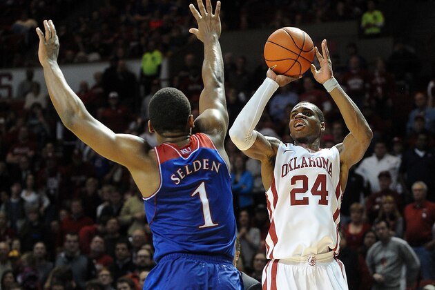 Jan 8, 2014; Norman, OK, USA; Oklahoma Sooners guard Buddy Hield (24) shoots the ball against Kansas Jayhawks guard Wayne Selden, Jr. (1) during the second half at Lloyd Noble Center. Mandatory Credit: Mark D. Smith-USA TODAY Sports