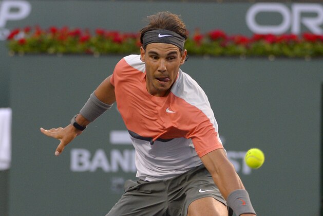 Rafael Nadal, of Spain, returns a shot to Alexandr Dolgopolov, of Ukraine, during their match at the BNP Paribas Open tennis tournament, Monday, March 10, 2014, in Indian Wells, Calif. Dolgopolov won 6-3, 3-6, 7-6 (5). (AP Photo/Mark J. Terrill)