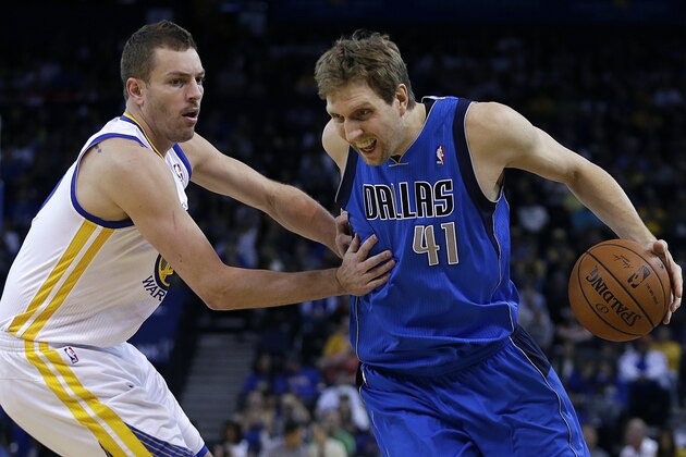 Dallas Mavericks' Dirk Nowitzki, right, of Germany, drives the ball against Golden State Warriors' David Lee during the first half of an NBA basketball game, Tuesday, March 11, 2014, in Oakland, Calif. (AP Photo/Ben Margot)
