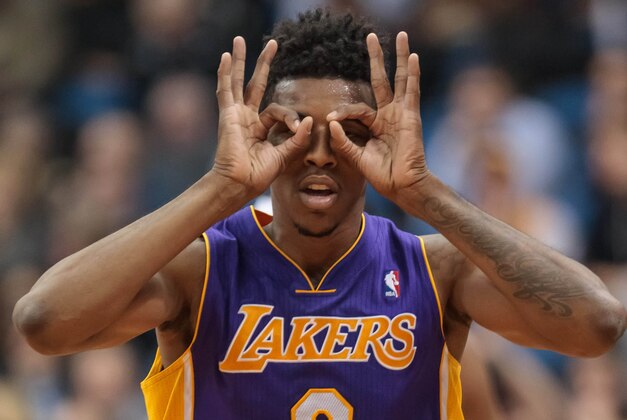 Feb 4, 2014; Minneapolis, MN, USA; Los Angeles Lakers forward Nick Young (0) celebrates his three pointer in the fourth quarter against the Minnesota Timberwolves at Target Center. Minnesota wins 109-99. Mandatory Credit: Brad Rempel-USA TODAY Sports