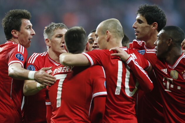 Bayern's Bastian Schweinsteiger, second left, celebrates with his teammates after scoring the opening goal during the Champions League round of 16 second leg soccer match between FC Bayern Munich and FC Arsenal in Munich, Germany, Wednesday, March 12, 2014. (AP Photo/Matthias Schrader)