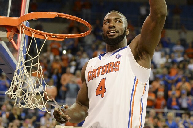 Florida's Patric Young holds up a piece of the net after the Gators became the first team in Southeastern Conference history to go 18-0 in league play, Saturday, March 8, 2014 in Gainesville, Fla.    Florida defeated Kentucky 84-65 Saturday in an NCAA college basketball game. (AP Photo/Phil Sandlin)