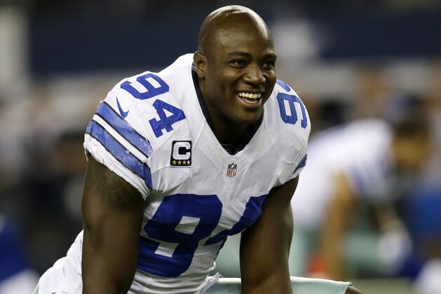 Dallas Cowboys defensive end DeMarcus Ware (94) smiles as he talks with teammates while stretching during warm ups before an NFL football game against the Washington Redskins, Sunday, Oct. 13, 2013, in Arlington, Texas. (AP Photo/Tim Sharp)