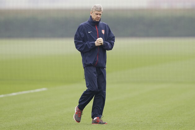 Arsenal's manager Arsene Wenger watches during a training session at their London Colney training ground, Monday, March 10, 2014. Arsenal will play in a Champions League last sixteen second leg soccer match against Munich in Germany on Tuesday. (AP Photo/Kirsty Wigglesworth)