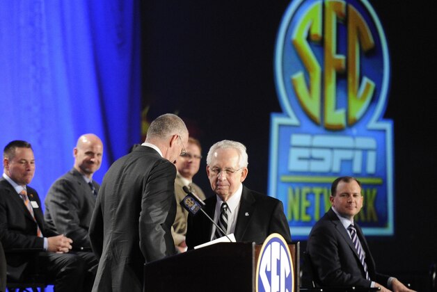Southeastern Conference Commissioner Mike Slive, second from right, takes the podium after ESPN President John Skipper during a news conference announcing the launching of the SEC Network in partnership with ESPN, Thursday, May 2, 2013, in Atlanta. (AP Photo/John Amis)