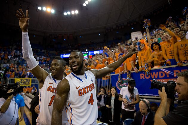 GAINESVILLE, FL - MARCH 08: Will Yeguete #15 and Patric Young #4 of the Florida Gators lead the crowd in singing 'happy birthday' to Michael Frazier II (not pictured) after the game against the Kentucky Wildcats at the Stephen C. O'Connell Center on March 8, 2014 in Gainesville, Florida. (Photo by Rob Foldy/Getty Images)