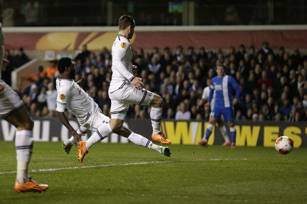 Tottenham's Emmanuel Adebayor, left, scores their second goal during the Europa League Group K soccer match between Tottenham Hotspur and Dnipro at White Hart Lane stadium in London, Thursday, Feb. 27, 2014.  (AP Photo/Matt Dunham)
