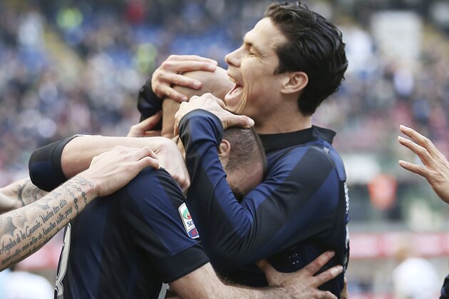 Inter Milan forward Rodrigo Palacio, center, of Argentina, celebrates with his teammate Brazilian midfielder Anderson Hernanes after scoring during the Serie A soccer match between Inter Milan and Torino at the San Siro stadium in Milan, Italy, Sunday, March 9, 2014. (AP Photo/Antonio Calanni)