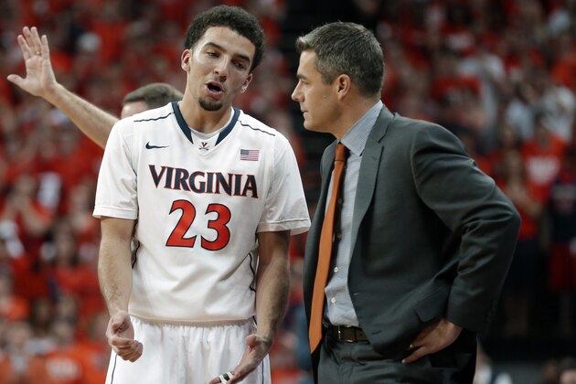 Virginia guard London Perrantes (23) talks with  head coach Tony Bennett during the second half of an NCAA College basketball game in Charlottesville, Va., Saturday, March 1, 2014. Virginia won the game 75-56. (AP Photo/Steve Helber)