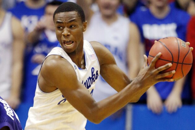 Kansas guard Andrew Wiggins, right, rebounds against Kansas State guard Marcus Foster, left, during the second half of an NCAA college basketball game in Lawrence, Kan., Saturday, Jan. 11, 2014. Kansas won 86-60. (AP Photo/Orlin Wagner)