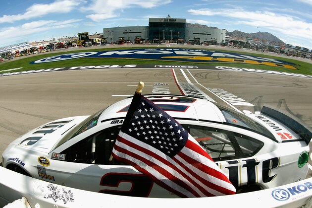 LAS VEGAS, NV - MARCH 09:  Brad Keselowski, driver of the #2 Miller Lite Ford, celebrates with an American flag after winning the NASCAR Sprint Cup Series Kobalt 400 at Las Vegas Motor Speedway on March 9, 2014 in Las Vegas, Nevada.  (Photo by Brian Lawdermilk/Getty Images)