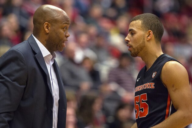 Oregon State head coach Craig Robinson, left, talks to guard Roberto Nelson (55) during the first half of an NCAA college basketball game against Washington State on Wednesday, Jan. 22, 2014, at Beasley Coliseum in Pullman, Wash. Oregon State won 66-55. (AP Photo/Dean Hare)