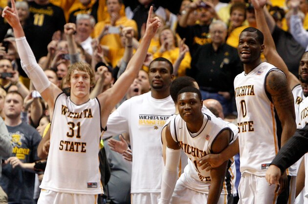Mar 9, 2014; St. Louis, MO, USA; Wichita State Shockers guard Ron Baker (31) celebrates with teammates as the final buzzer sounds and the Wichita State Shockers defeat the Indiana State Sycamores to win the Missouri Valley Conference basketball tournament at Scotttrade Center.Wichita won 83-69. Mandatory Credit: Scott Kane-USA TODAY Sports