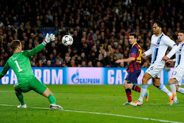 BARCELONA, SPAIN - MARCH 12:  Lionel Messi of Barcelona flicks the ball past goalkeeper Joe Hart of Manchester City to score the opening goal during the UEFA Champions League Round of 16, second leg match between FC Barcelona and Manchester City  at Camp Nou on March 12, 2014 in Barcelona, Spain.  (Photo by David Ramos/Getty Images)