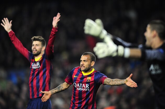 Barcelona's Gerard Pique, Daniel Alves and  goalkeeper Victor Valdes, from left to right, gesture during a Champions League, round of 16, second leg, soccer match between FC Barcelona and Manchester City at the Camp Nou Stadium in Barcelona, Spain, Wednesday March 12, 2014. (AP Photo/Manu Fernandez)