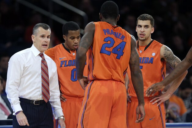 Florida head coach Billy Donovan, left, talks with his team during a timeout during the second half of an NCAA college basketball game against Memphis in New York, Tuesday, Dec. 17, 2013. Florida defeated Memphis 77-75. (AP Photo/Seth Wenig) Florida head coach Billy Donovan, left, talks with his team during a timeout during the second half of an NCAA college basketball game against Memphis in New York, Tuesday, Dec. 17, 2013. Florida defeated Memphis 77-75. (AP Photo/Seth Wenig)